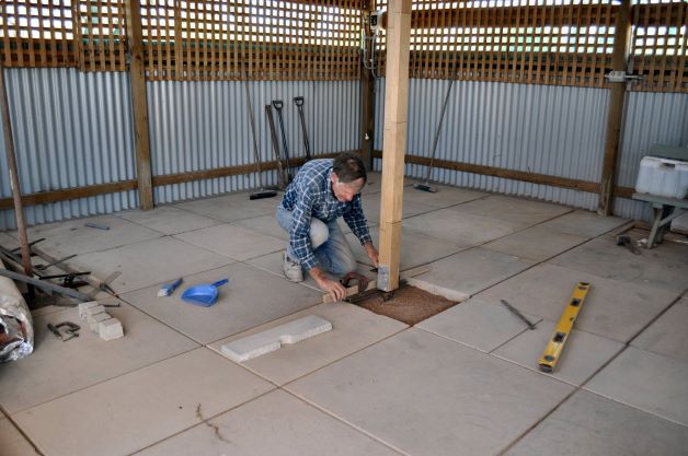Glen using his engineer skills to lay concrete slabs flat in the Latifrons Shed. They are STILL secure and flat!